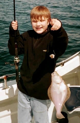 Fish Finders Seattle Fishing Charters- a boy fishing a fish