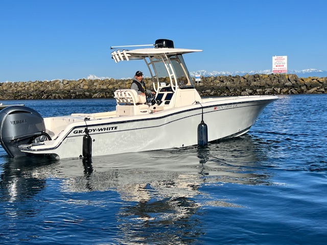 Fish Finders Seattle Fishing Charters- A man driving a boat