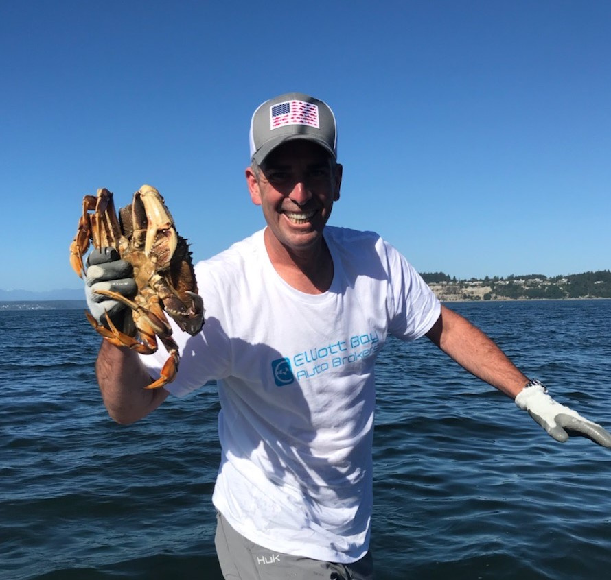 Fish Finders Seattle Fishing Charters- A man holding with crab