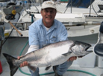 Fish Finders Seattle Fishing Charters- A Man carries a big fish