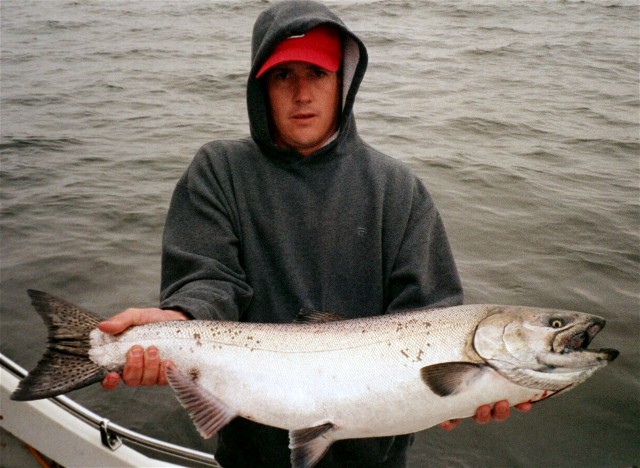 Fish Finders Seattle Fishing Charters- A man holding with a fish