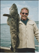 Fish Finders Seattle Fishing Charters- A man carries a big fish