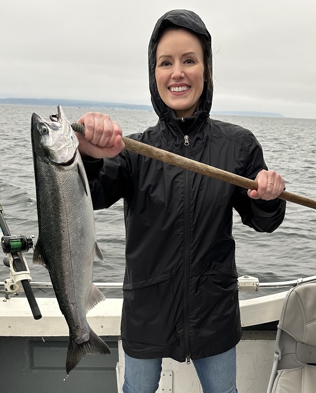 Fish Finders Seattle Fishing Charters- a women fishing a fish